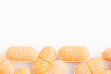 Closeup Vitamin C Tablets on White Background.