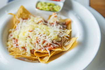 mexican food nachos with sauce and cheese