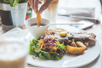 Beef grill steak with salad and fried potato wedges