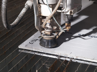 water pressure cutting through stainless steel materials