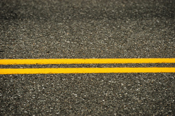 Fototapeta premium double yellow line on asphalt street surface