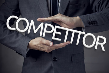 Businessman in suit with two hands in position to protect the wo