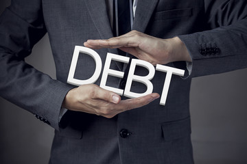 Businessman in suit with two hands in position to protect the wo