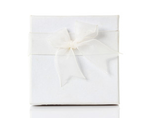 White gift box with white ribbon bow, isolated on white