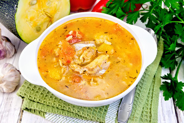 Soup fish with zucchini and peppers on napkin