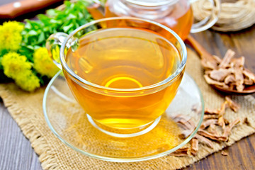 Tea of Rhodiola rosea in glass cup on sacking