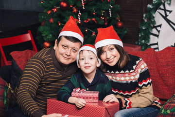 Christmas family of three persons in red hats