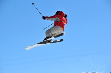 skier in red and grey jumping