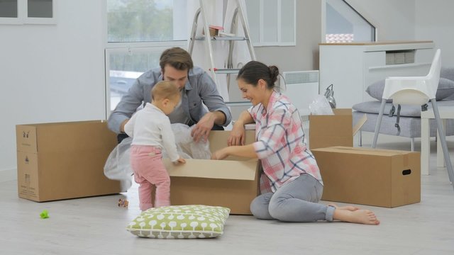 Young family moving into new home, unpacking