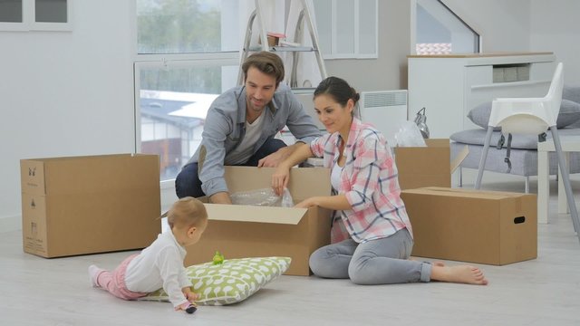 Young family moving into new home, unpacking