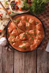 Indian tikka masala chicken on the table. vertical top view
