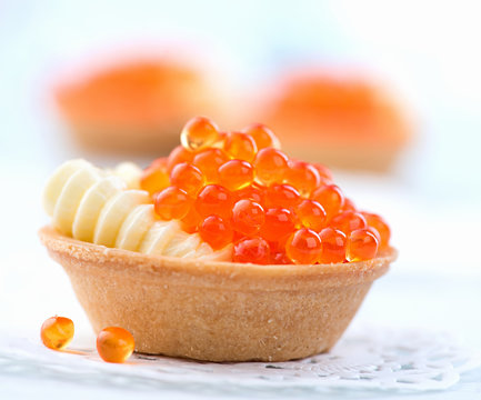 Tartlet with red caviar closeup. Gourmet food