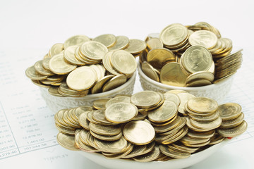 Pile of gold coins in ceramic as ship