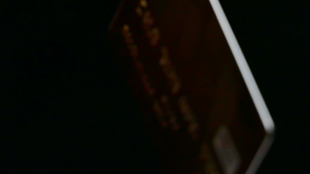 
Credit card on  black background rotates. 4K 3840x2160 
Blurred scene
