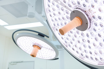 Two surgical lamps in operation room take with selective color technique and art lighting