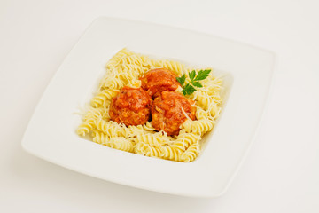 Fusilli pasta with meatball at white plate