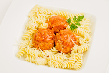 Fusilli pasta with meatball at white plate