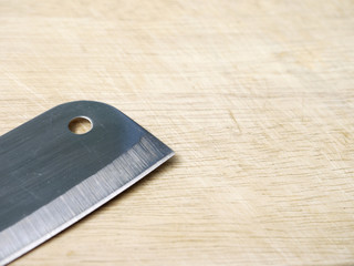 closeup kitchen knife on wooden cutting board