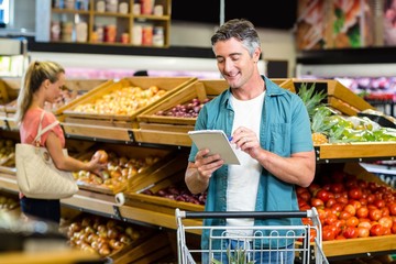 Smiling man looking at the grocery list