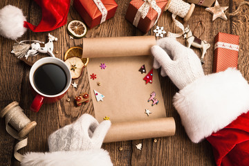 Santa Claus with gifts and wish list
