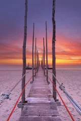 Poster Seaside jetty at sunrise on Texel island, The Netherlands © sara_winter