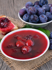 Homemade plum jam in white bowl