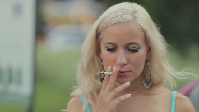 Woman smoking a cigarette on the street