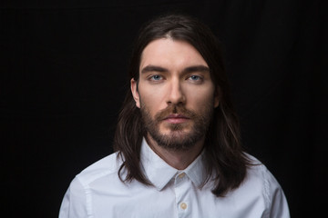 Man with beard and long hair looking at camera