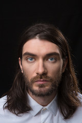 Obraz premium Man with beard and long hair looking at camera