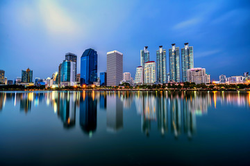 Fototapeta na wymiar Panorama of Bangkok city downtown at twilight with reflection sk