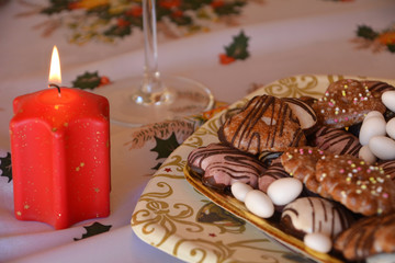 Fototapeta na wymiar Christmas decorated gingerbread cookies on the table with lighted candle