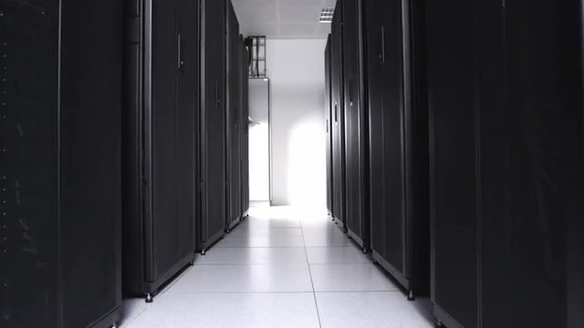 Rows of racks with telecommunication equipment in room of data center