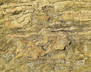 Fragment of yellow stone cliff