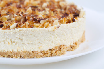 Homemade coconut cheesecake with caramel and assorted nuts