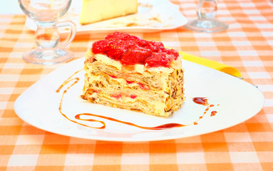 Cake Napoleon with strawberry on the plate