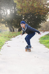 Fototapeta premium boy rides a skateboard in the park