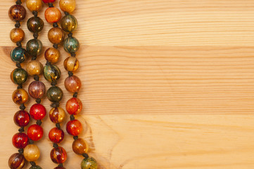 Beads on a wooden background