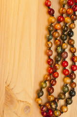 Beads on a wooden background