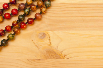 Beads on a wooden background