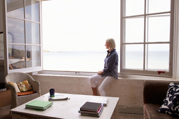 Woman Sitting At Window And Looking At Beautiful Beach View