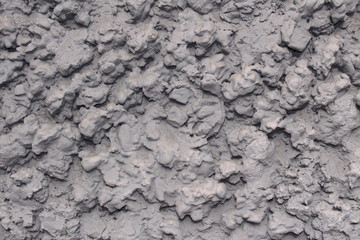 Vintage or grungy gray background of wall with mortar (mixture of natural cement and stone), old texture as a retro pattern layout of construction.