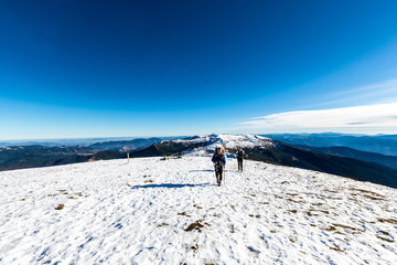Fototapeta na wymiar walking couple on the top of mountain