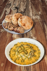 Russian Salad with Baguette and Pita Bread on Old Cracked Wooden Table