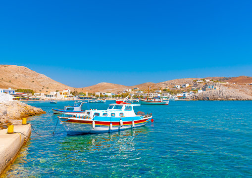 Fototapeta traditional fishing boats docked in the port of Pserimos island in Greece
