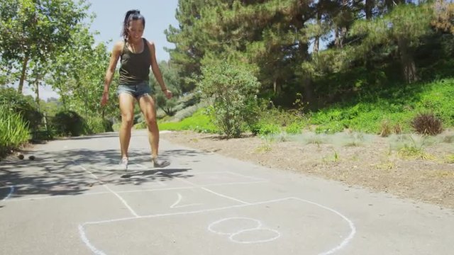 Young woman reliving her childhood at the park