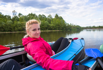 Fototapeta premium Young people are kayaking on a river in beautiful nature. Summer sunny day outdoor
