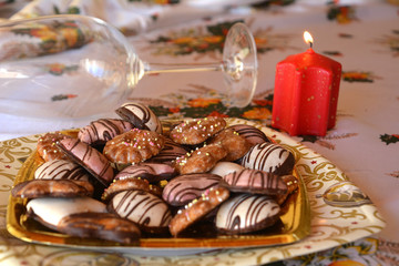 Christmas decorated gingerbread cookies on the table with lighted candle