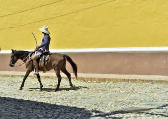 Cuban local man on horse on street in Trinidad, Cuba.