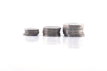 pile of small coins on a white background.