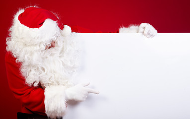 Santa Claus pointing in white blank sign with smile,christmas  r